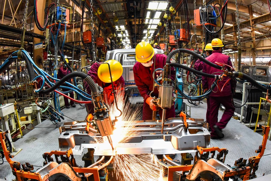Workers weld at a workshop of an automobile manufacturing enterprise in Qingzhou City, east China's Shandong Province, Feb. 28, 2021. (Photo by Wang Jilin/Xinhua) XxjwsmE007011 20210318 CBMFN0A004