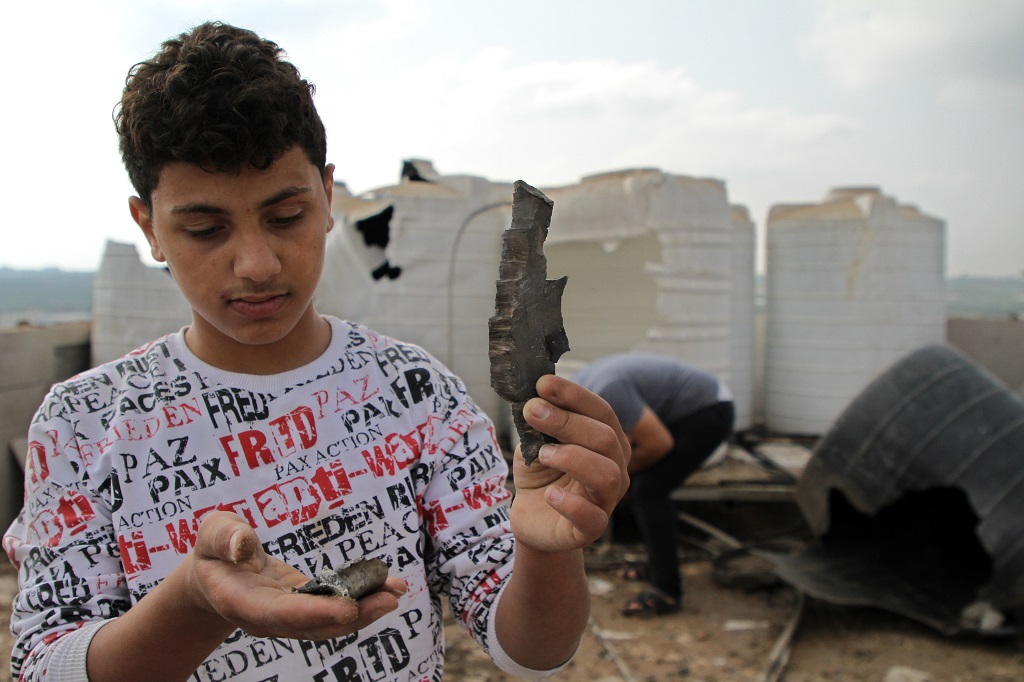 A Palestinian inspects the damage of a house following Israeli airstrikes in Gaza City, on May 11, 2021. (Photo by Rizek Abdeljawad/Xinhua) CcrbeeE007046 20210512 CBMFN0A003