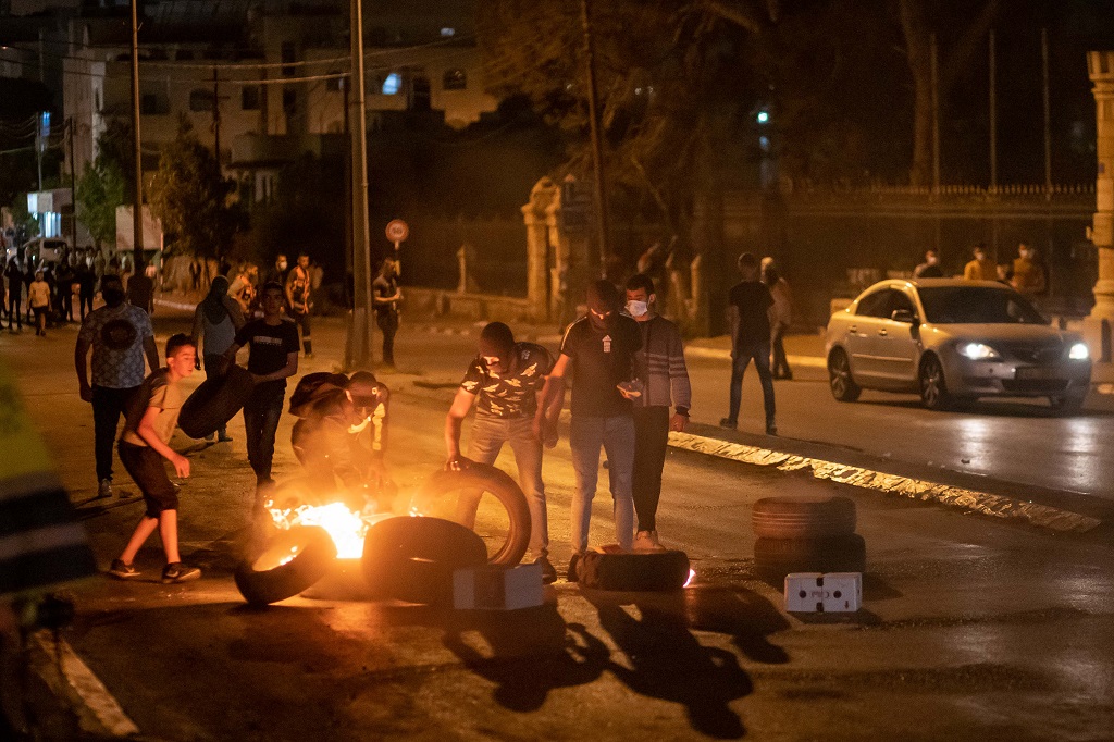 Protesters burn tires during clashes with Israeli border police following an anti-Israel protest against the violence in Jerusalem, in the West Bank city of Bethlehem, on May 11, 2021. (Photo by Luay Sababa/Xinhua) CcrbeeE007046 20210512 CBMFN0A004