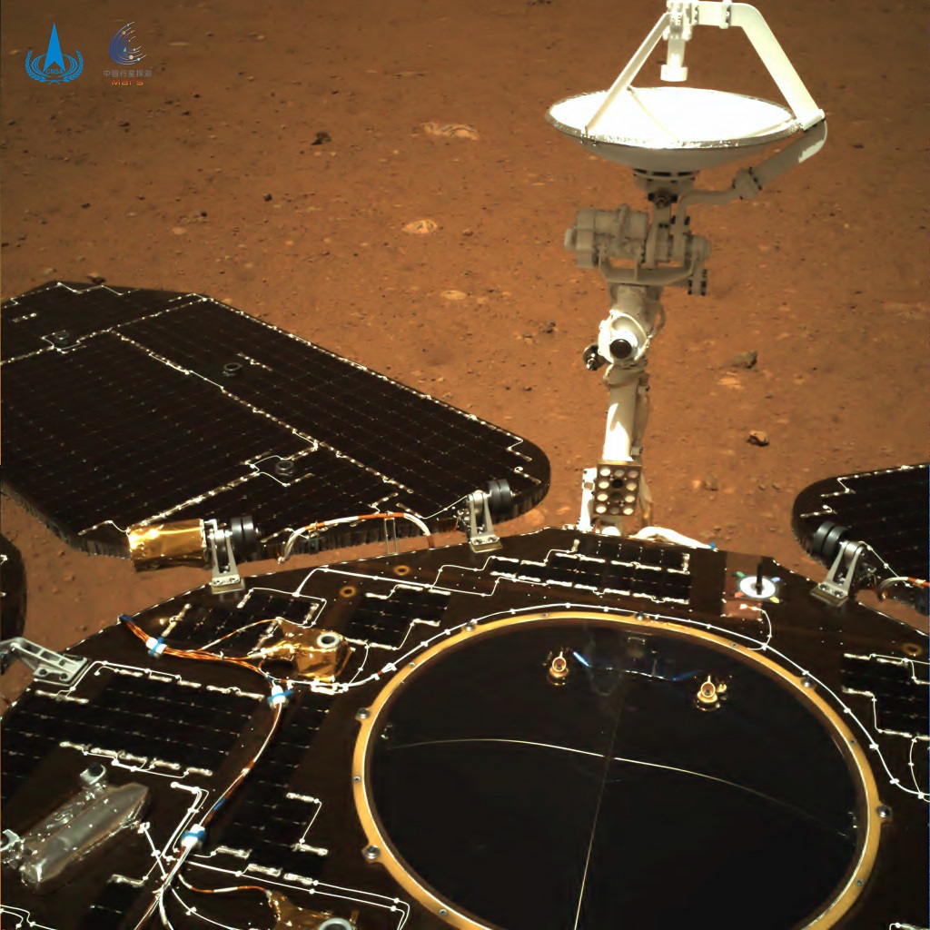 Color photo taken by Zhurong's navigation camera shows that the rover's solar panels and antenna are seen unfolded, and the red soil and rocks on the Martian surface are clearly visible. (China National Space Administration/Handout via Xinhua) XxjwshE007088 20210522 CBMFN0A005