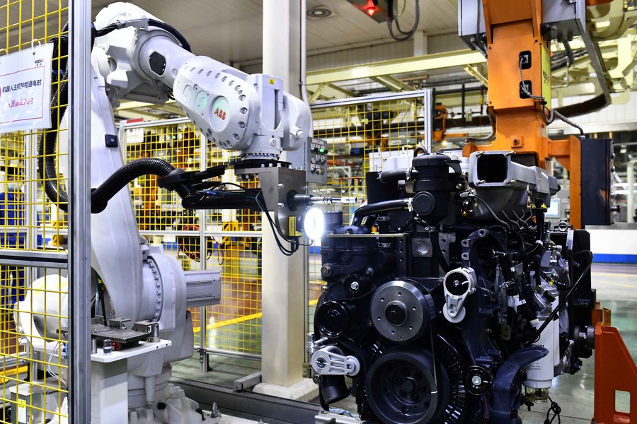 Robotic arms assemble engines on an assembly line at a workshop of the Weichai Power Co., Ltd. in Weifang City, east China's Shandong Province, April 22, 2021. (Xinhua/Guo Xulei) XxjwshE007051 20210527 CBMFN0A003