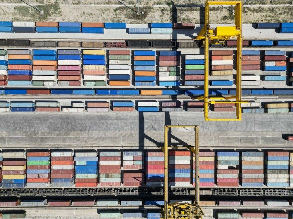 This aerial photo taken on May 11, 2023 shows a crane loading containers at a railway port in Horgos, northwest China's Xinjiang Uygur Autonomous Region. (Xinhua/Hao Zhao)
