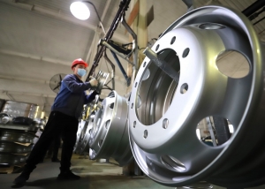 A staff member works in a workshop of a vehicle wheel hub manufacturer in Yutian County of Tangshan City, north China's Hebei Province, April 16, 2021. (Photo by Li Yang/Xinhua)
