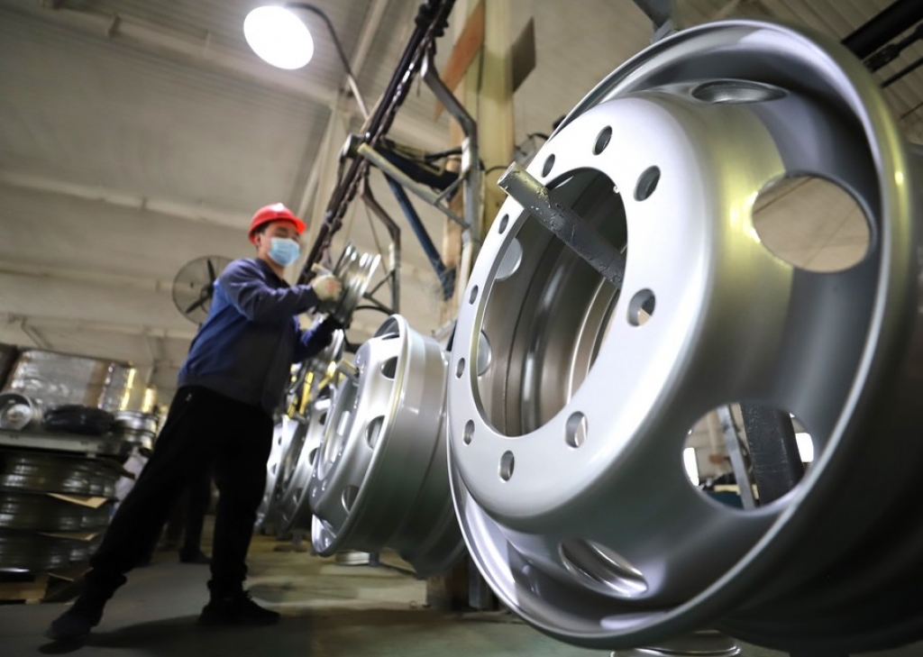 A staff member works in a workshop of a vehicle wheel hub manufacturer in Yutian County of Tangshan City, north China's Hebei Province, April 16, 2021. (Photo by Li Yang/Xinhua)