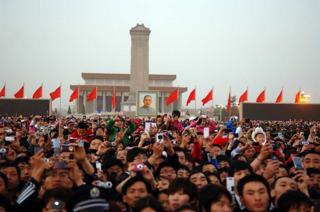 People watch flag raising at the Tiananmen Square in Beijing, capital of China, May 1, 2011. More than ten thousand people watched flagraising ceremony at the Tiananmen Square to celebrate May Day. (Xinhua/Zhao Wanwei)