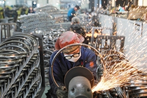 Workers polish steel rims for bicycles for export at a workshop of a foreign trade enterprise in Tianmushan Town of Lin 'an District, Hangzhou City, east China's Zhejiang Province, April 16, 2021. (Photo by unreguser/Xinhua)