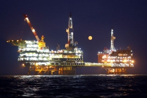 A full moon is seen over an oil production platform in Bohai Oilfield, Sept. 29, 2023. (Photo by Du Penghui/Xinhua)